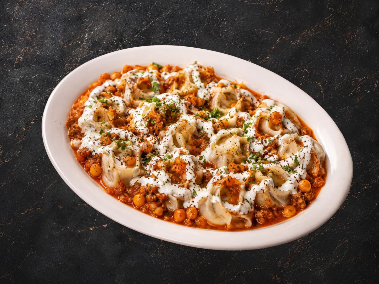 Mantu dumplings with yogurt and chickpea sauce